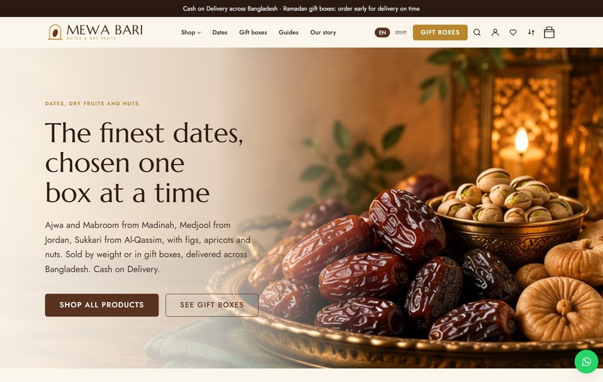 Homepage of the Mewa Bari dates and dry fruits store template, with a brass tray of dates and the headline “The finest dates, chosen one box at a time”